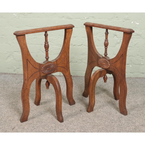 271 - A pair of antique carved oak Coffin stands. Having folding supports. Height 63cm.