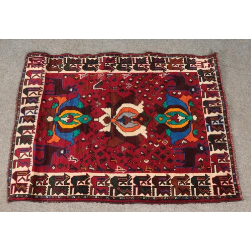 273 - An Eastern red ground wool rug. 165cm x 130cm.