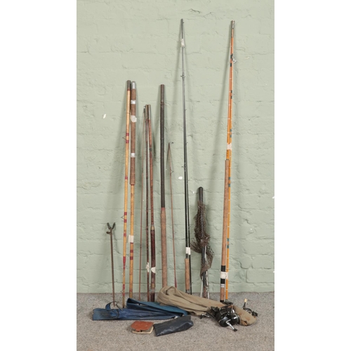 280 - A quantity of vintage fishing equipment, including intrepid reels, cane stake, fly case and cane rod... 