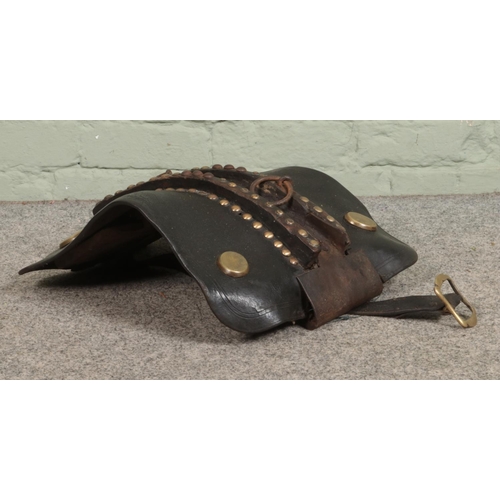 289 - A vintage leather saddle, with studded and hooped detailing.