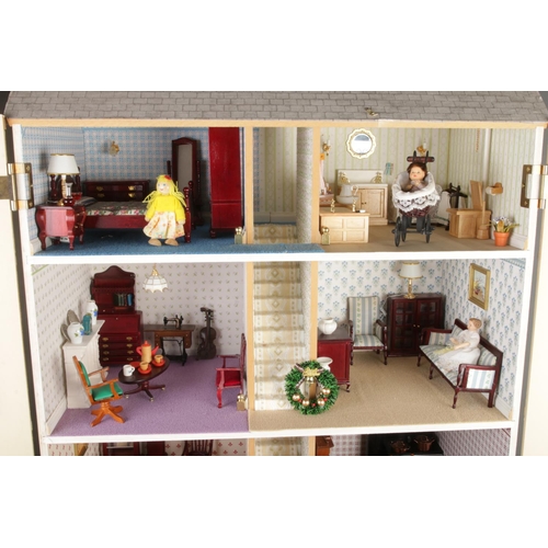 305 - A large three storey fitted doll house complete with electronic wiring and good selection of furnitu... 