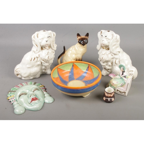 62 - A collection of ceramics. Includes Art Deco style wall plaque and bowl, mantel dogs, Goebel etc.