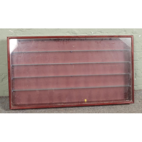 357 - A wall hanging cabinet with glass front and four glass shelves to interior. 59.5cm x 107cm x 9cm.