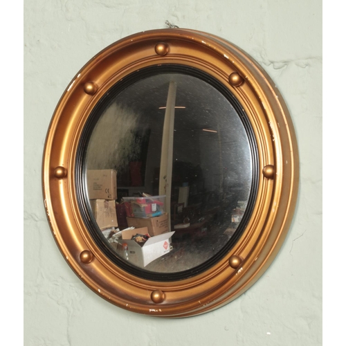 364 - A circular gilt framed convex mirror. Diameter: 34cm.