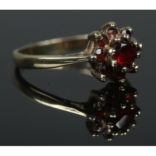 402 - A gold cluster ring, set with garnets. Tests as 9ct. Size K½. Total weight: 1.7g