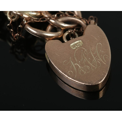 407 - A 9ct Gold rope twist bracelet chain with heart shaped locket clasp. The locked monogrammed for KAH.... 