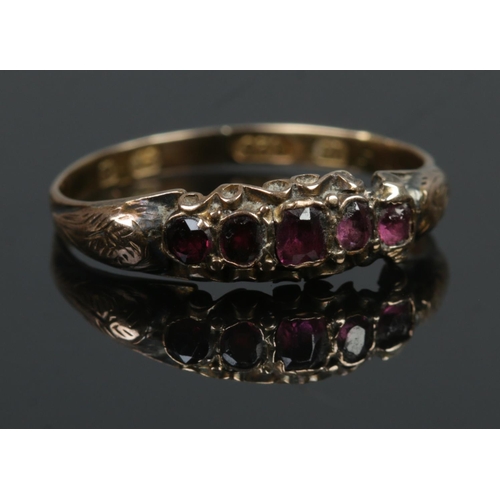 426 - A Victorian 15ct Gold ring, set with five amethyst coloured stones. Size P½. Assayed Birmingham, 186... 