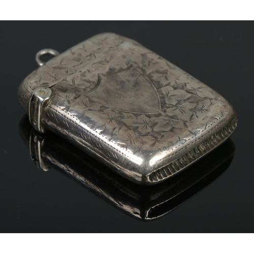 436 - A late Victorian silver vesta case, engraved with ivy leaf decoration and blank shield crest to the ... 