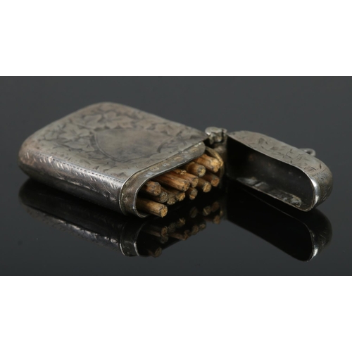 436 - A late Victorian silver vesta case, engraved with ivy leaf decoration and blank shield crest to the ... 