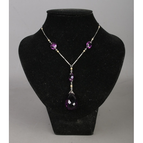 438 - An art deco Platinon necklace, set with small simulated pearls and amethyst coloured stones.