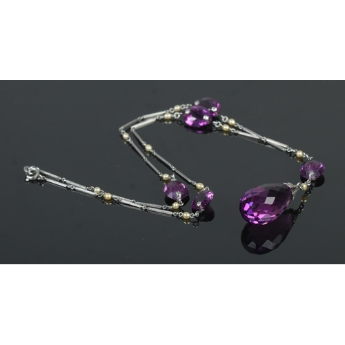 438 - An art deco Platinon necklace, set with small simulated pearls and amethyst coloured stones.