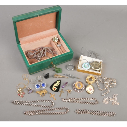 439 - A vintage jewellery box with contents of jewellery. Includes enamelled fob watch, silver rings, whit... 