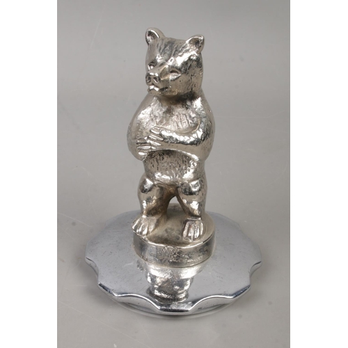 452 - A novelty white metal car mascot in the form of a standing bear. Approx. height 11cm.