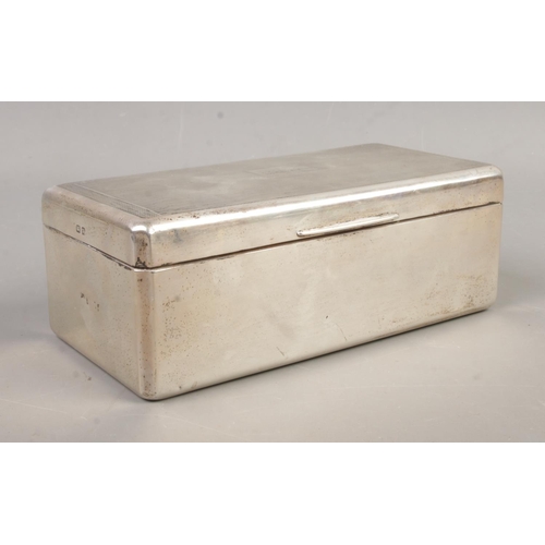 467 - A large hinged silver mounted cigarette box. Assayed Birmingham, 1939 by William Neale. Total weight... 