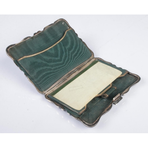 476 - An early Twentieth Century silver hinged card case, heavily engraved with leaf detailing and central... 