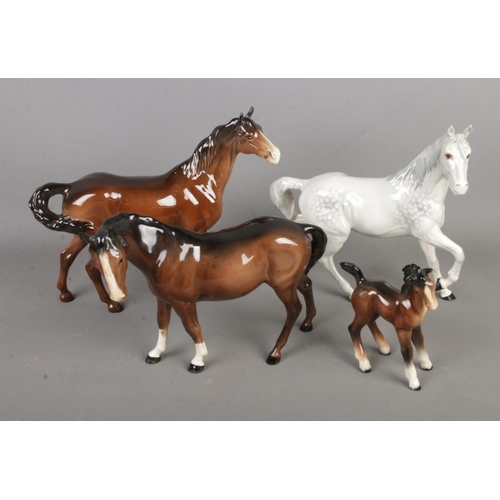 495 - Four Beswick horses including trotting Dapple and foal examples.