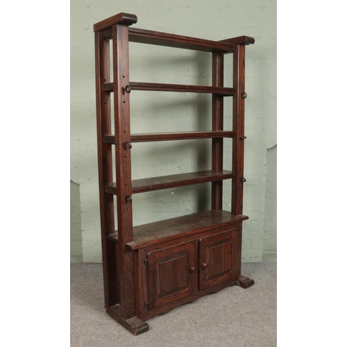 499 - An oak open back brutalist 'Cheese Press' shelving unit, with lower cupboard doors. Height: 196cm, W... 