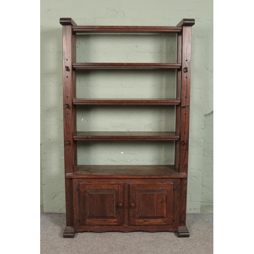 499 - An oak open back brutalist 'Cheese Press' shelving unit, with lower cupboard doors. Height: 196cm, W... 