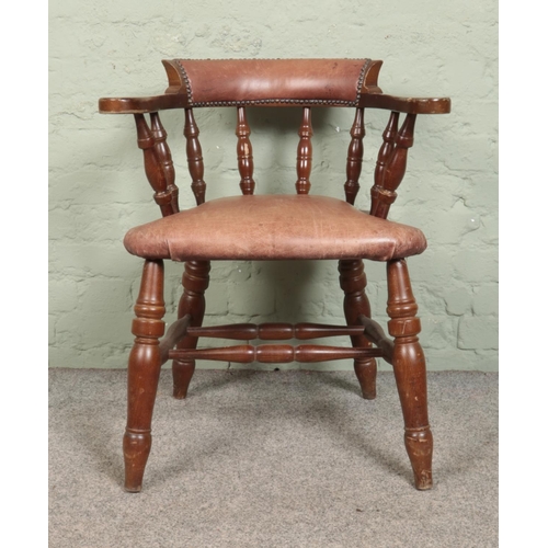 522 - A smoker's bow armchair, with leather and studded base and back rest, turned supports and double str... 