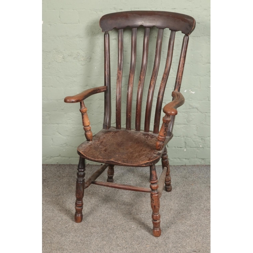 528 - An early 20th century lathe back elbow chair.