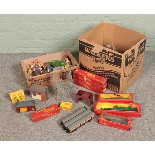 215 - Two boxes of OO gauge model railway track, carriages and accessories to include boxed Tri-Ang carria... 