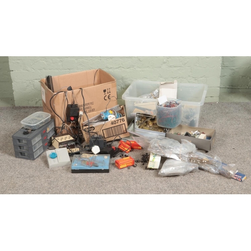 242 - Two boxes of assorted model railway spares and repairs to include wiring and controllers, railway wh... 