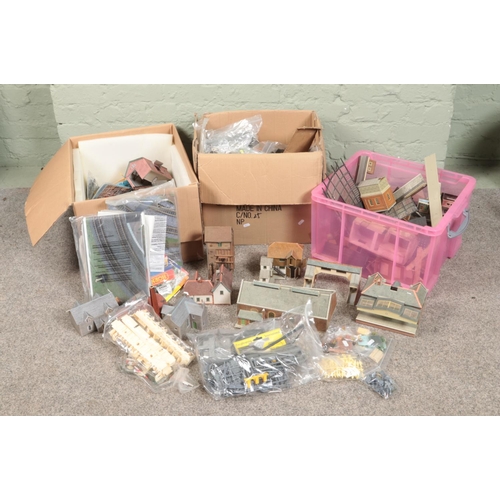 244 - Three large boxes of railway diorama accessories including a large quantity of buildings, miniatures... 