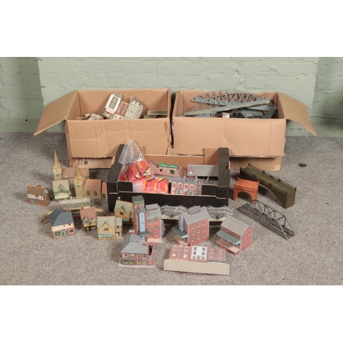 256 - Three large boxes of railway diorama accessories including a large quantity of buildings, miniatures... 