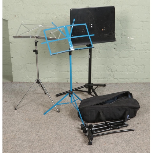 304 - A selection of four adjustable music stands.