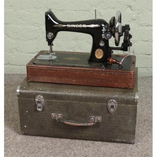 315 - A vintage Singer Sewing machine in faux crocodile skin case