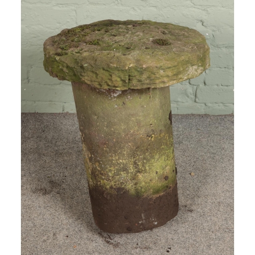 339 - A large hand carved saddle stone top on married stone base.