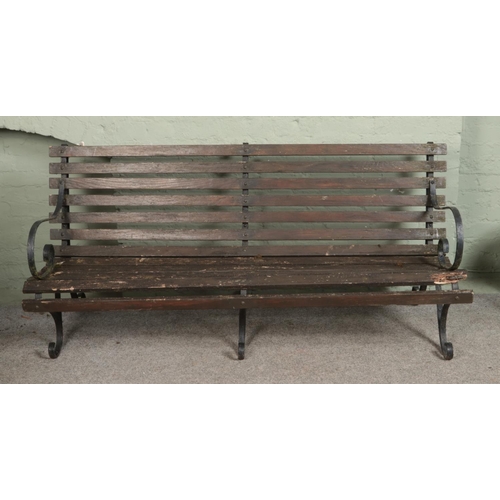 345 - A vintage wrought iron 6ft garden bench with triple base