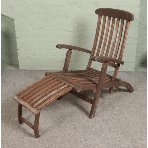 347 - A teak and brass garden patio lounger.