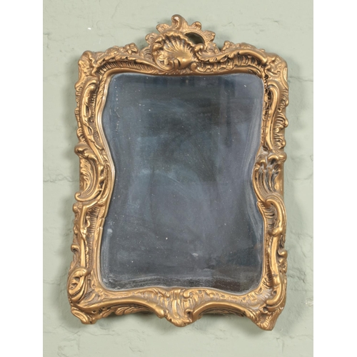 371 - A gilt plaster Florentine Rococo style wall mirror.

52x38cm