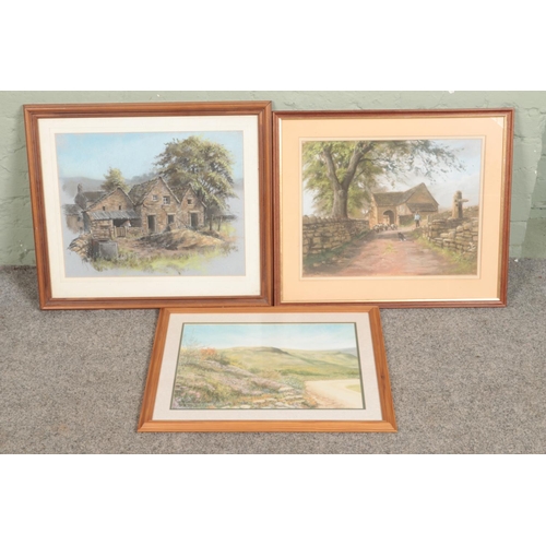 377 - A collection of three pastel artworks of village/countryside theme including examples signed 