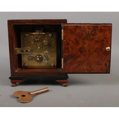 460 - A burr walnut mantel clock of square form with engraved dial with roman numeral markers behind a bev... 