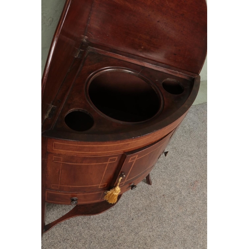 498 - A Victorian mahogany inlaid corner wash stand, with cupboard door over singular draw flanked by to f... 