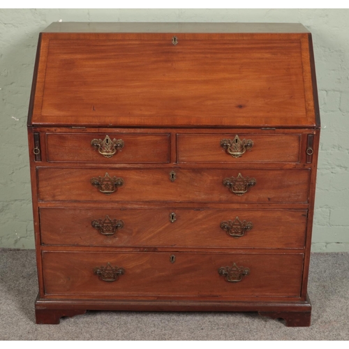 518 - A large mahogany four drawer bureau with brass escutcheons and handles with fitted interior and leat... 