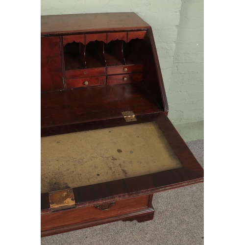 518 - A large mahogany four drawer bureau with brass escutcheons and handles with fitted interior and leat... 