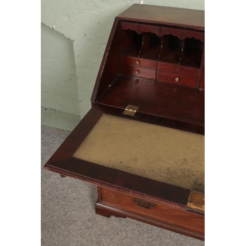 518 - A large mahogany four drawer bureau with brass escutcheons and handles with fitted interior and leat... 