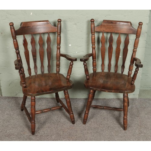 519 - A pair of wooden slat back chairs.