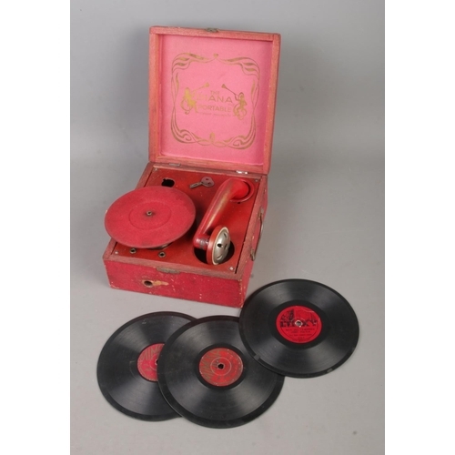 160 - The Diana Portable child's clockwork gramophone in red case along with three orchestra records.