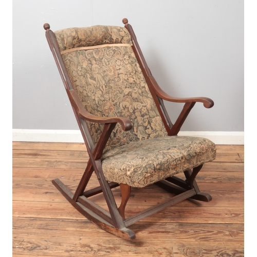 517 - An Edwardian upholstered mahogany rocking chair.