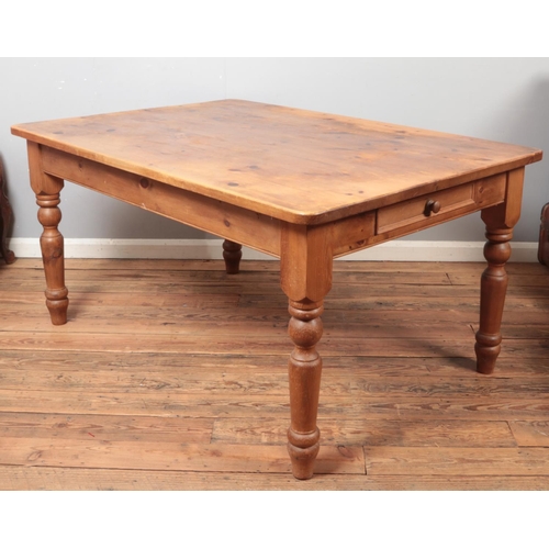 518 - A large pine Farmhouse style table with drawers to both ends.