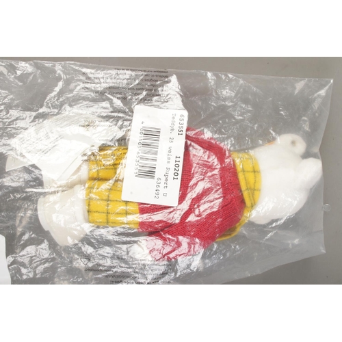 63 - A Steiff Rupert Bear; 653551, in white, still in plastic packing bag. With yellow tag and button in ... 