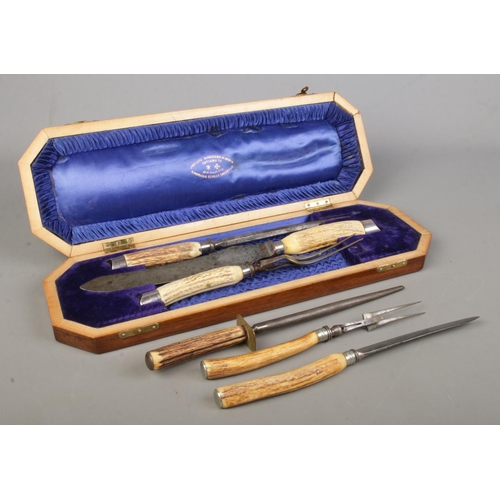 74 - A cased three piece Joseph Rodgers bone handled carving set, together with one other uncased example... 