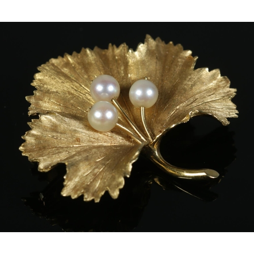 An 18ct Gold maple leaf brooch, set with three pearls. Stamped 18 and 750 to the reverse; Bears London import mark and HLB initials, possibly for Harris Leon Brown. 4cm at widest point. Total weight: 11g.