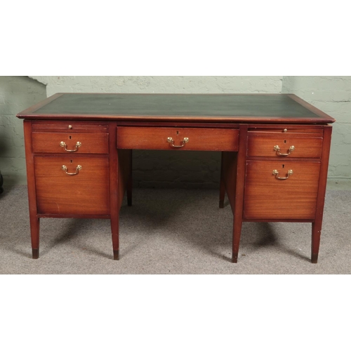 506 - A quality mahogany twin pedestal desk with leather inset top and brushing slides stood on brass capp... 