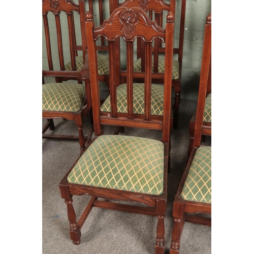 533 - A set of ten oak dining chairs, containing two carvers. Featuring carved detailing to top of backres... 