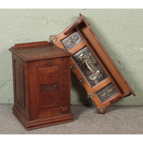 551 - An oak coal box with carved panel front with 